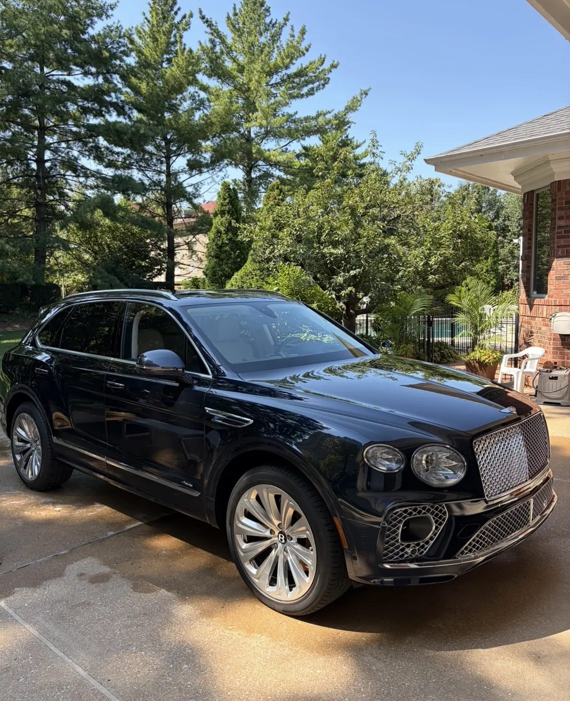 Front three quarter view of a dark blue 2023 Bentley Bentayga Azure after a ceramic maintenance wash by David's Auto Spa in University City, Missouri