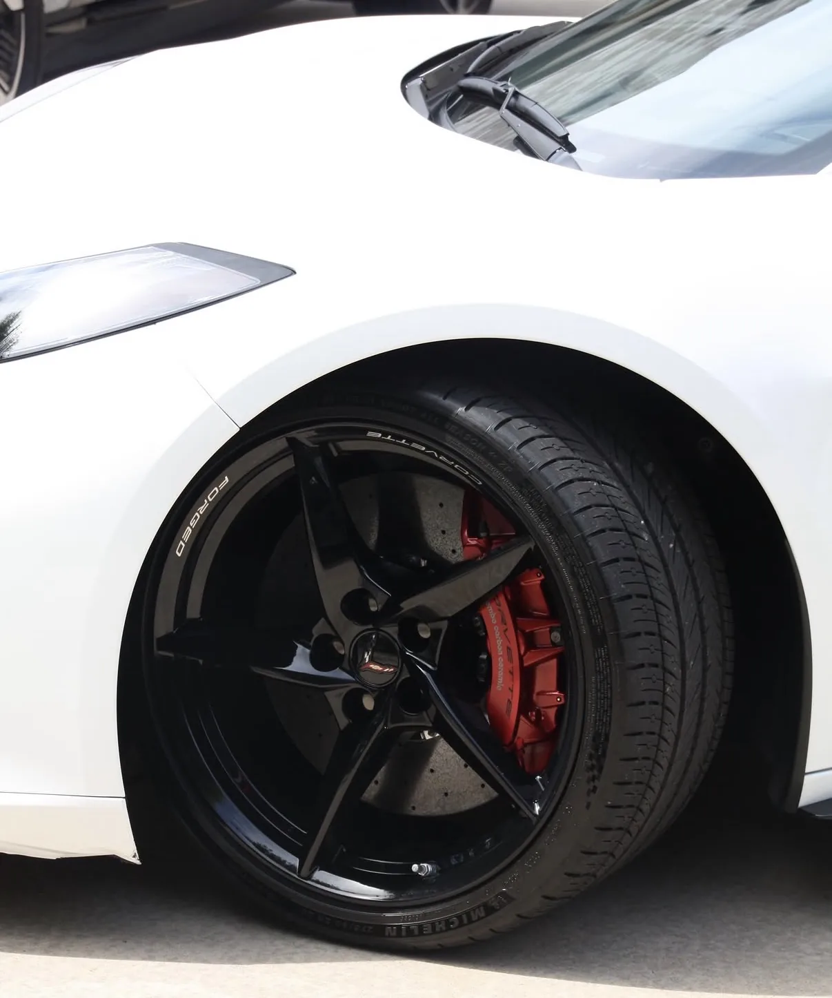 Detail of a Chevrolet Corvette wheel and red brake caliper